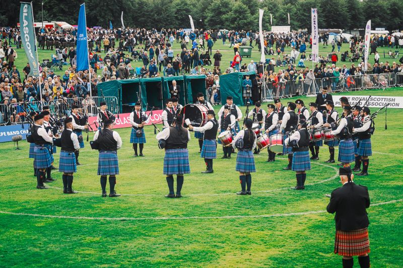 Group of bagpipers and drummers performing at the World Pipe Band Championships 