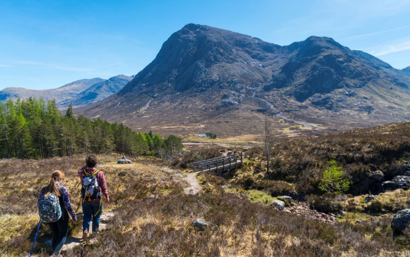 Walkers out in Scotland's mountainous countryside.