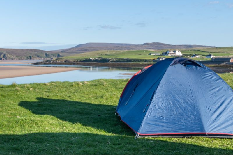 Blue camping tent on beach front 