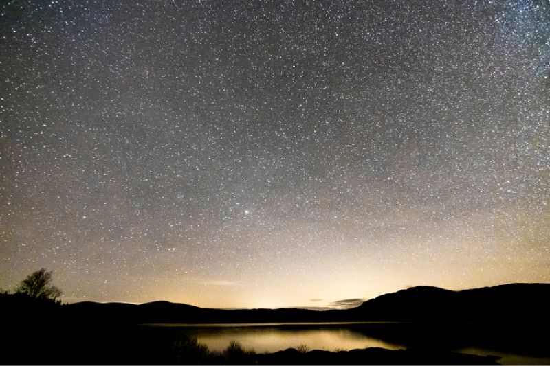 Clattering Shaws Loch at night with stars in the sky