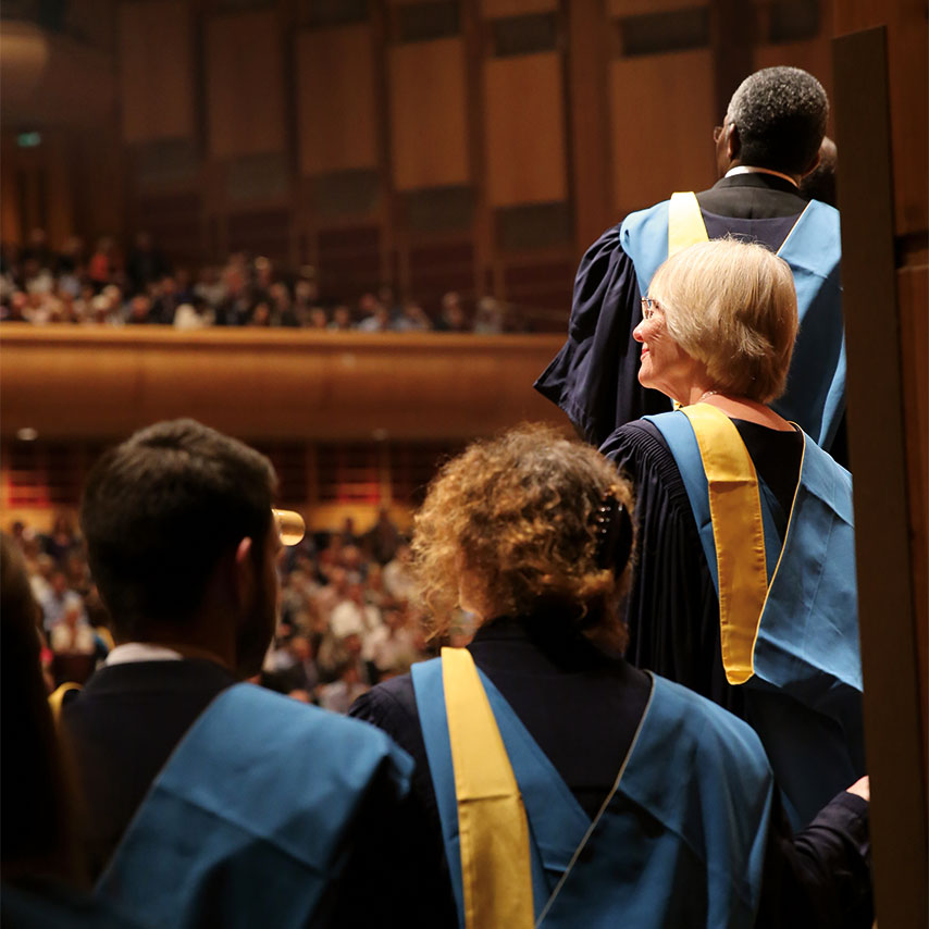Image of students going on stage for the graduation ceremony.