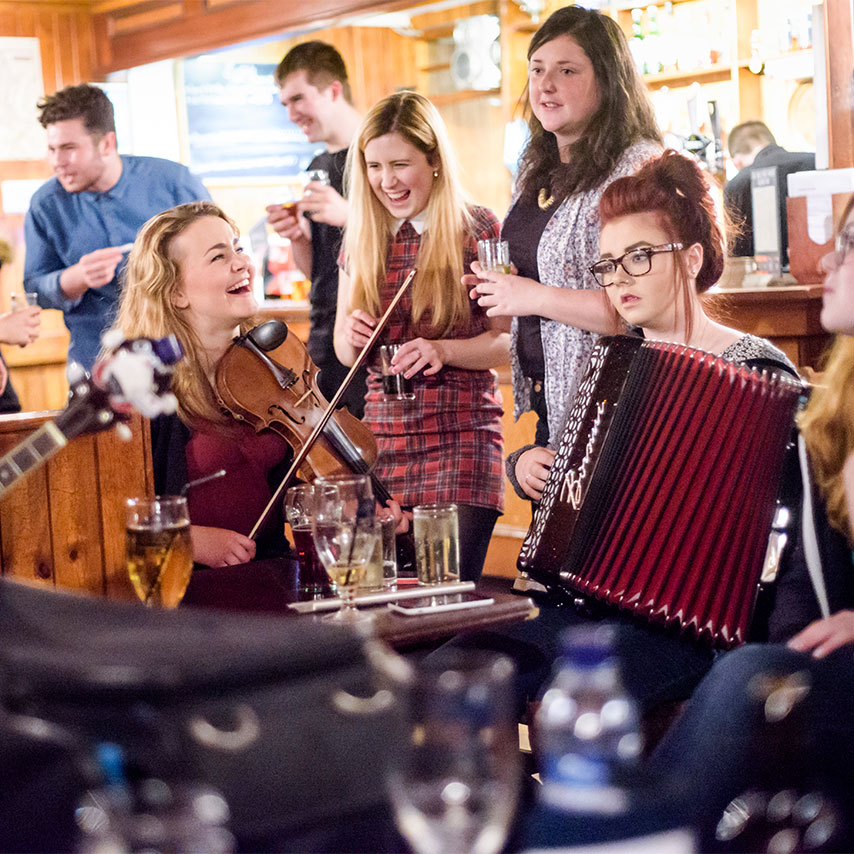 Image of a group of traditional Scottish folk musicians in a pub.