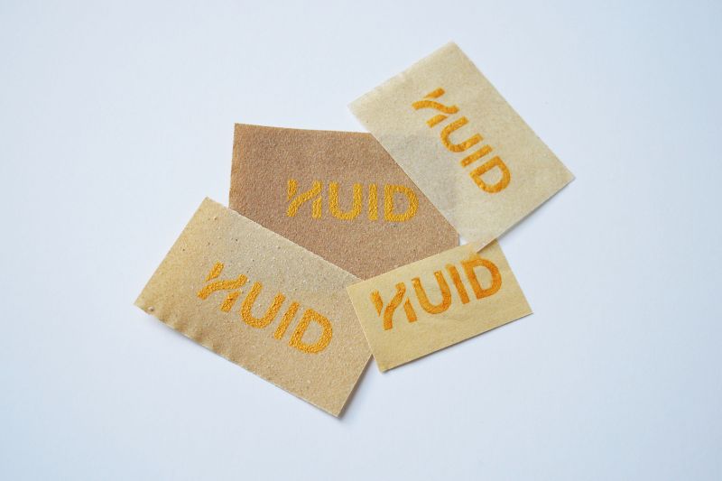 Several pieces of print with HUID Logo on them