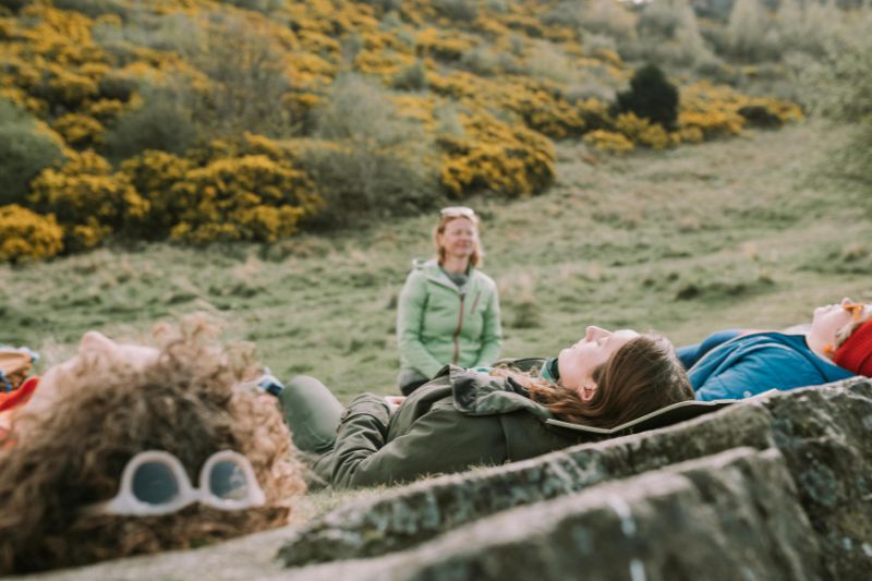 Group of woman practising mindfulness outdoors in Scotland with company WanderWomen