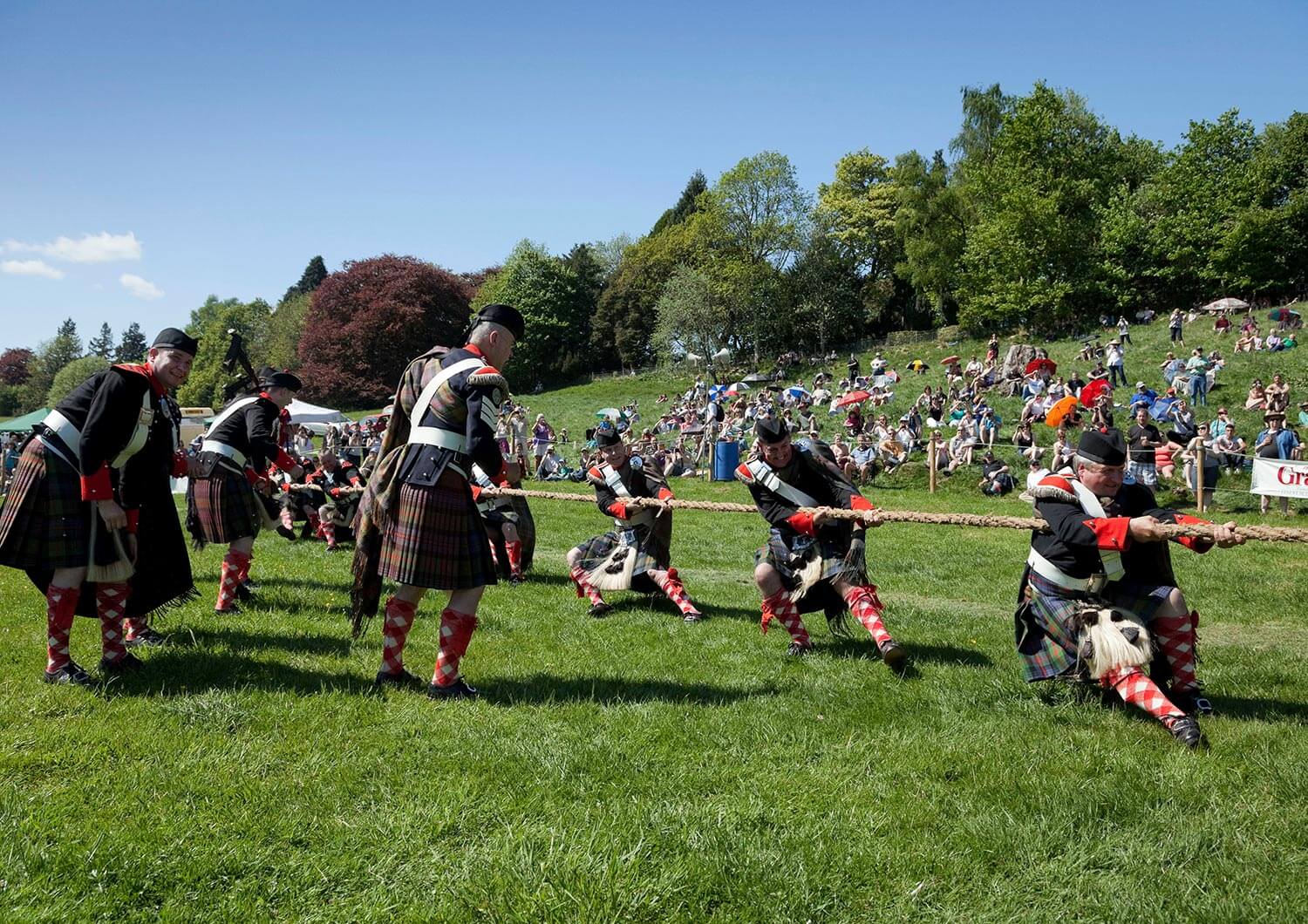 People competing in a tug o'war competition at the Scottish Highland Games 